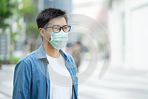 HandsomeMan wearing face mask protect filter against air pollution PM2.5 or wear N95 mask. protect pollution, anti smog and