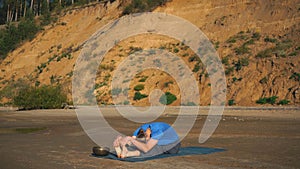 Handstand yoga pose by man on the beach near the ocean