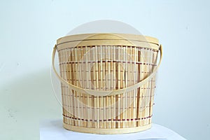 Handwoven bamboo basket with handle, traditional handicraft concept, container