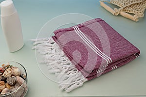 Handwoven hammam Turkish cotton towel on glass background