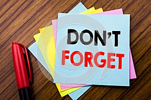 Handwriting Announcement text Do Not Forget. Concept for Don t memory Remider Written on sticky stick note paper with wooden back
