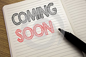 Handwriting Announcement text showing Coming Soon. Business concept for Under Construction written on notebook with copy space on
