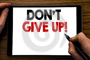 Handwriting Announcement text showing Don t Give Up. Business concept for Motivation Determination, Written on tablet laptop, wood