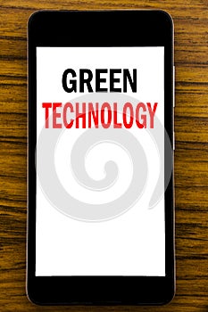 Handwriting Announcement text showing Green Technology. Business concept for campaign, Written on mobile phone cellphone with wood