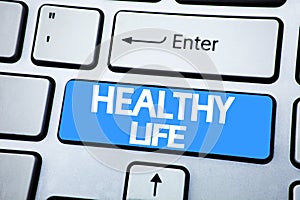 Handwriting Announcement text showing Healthy Life. Business concept for Good Health Food written on red key on the keybord backgr