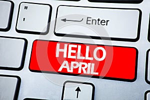 Handwriting Announcement text showing Hello April. Business concept for Spring Welcome written on red key on the keybord backgroun