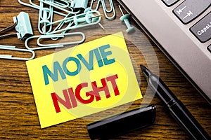 Handwriting Announcement text showing Movie Night. Business concept for Wathing Movies written on sticky note paper on the wooden