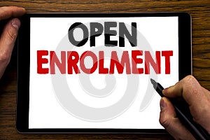 Handwriting Announcement text showing Open Enrolment. Business concept for Medicine Doctor Enroll Written on tablet laptop, wooden