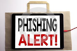 Handwriting Announcement text showing Phishing Alert. Business concept for Fraud Warning Danger Written on shopping bag and tablet