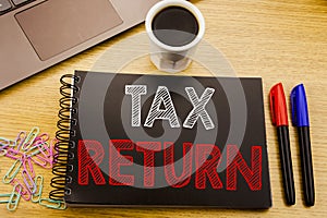 Handwriting Announcement text showing Tax Return. Business concept for Accounting Money Return written on notebook book on the woo