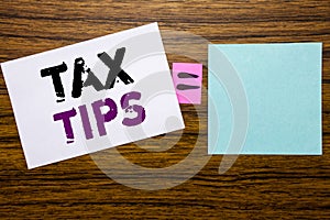 Handwriting Announcement text showing Tax Tips. Business concept for Tip Forn Taxes written on sticky note paper on wooden backgro