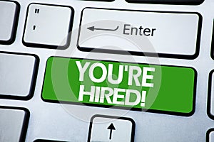 Handwriting Announcement text showing You Are Hired. Business concept for Hiring Employee Worker written on blue key on the keybor