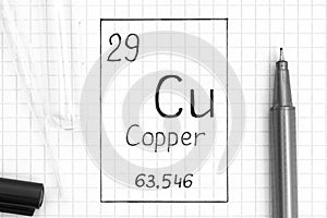 Handwriting chemical element Copper Cu with black pen, test tube and pipette