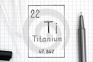 Handwriting chemical element Titanium Ti with black pen, test tube and pipette