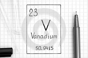 Handwriting chemical element Vanadium V with black pen, test tube and pipette