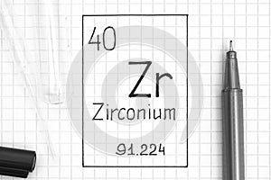 Handwriting chemical element Zirconium Zr with black pen, test tube and pipette