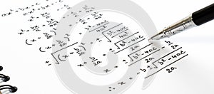 Handwriting of mathematics quadratic equation formula on examination, practice, quiz or test in math class.