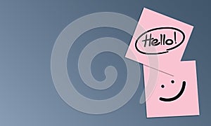 Handwriting of message Hello and smile face on pink sticky note on blue background with your copy space