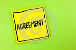 Handwriting text Agreement. Concept meaning Business or personal closures made easy with better guidance written on Yellow Sticky