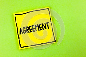 Handwriting text Agreement. Concept meaning Business or personal closures made easy with better guidance written on Yellow Sticky photo