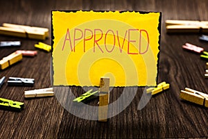 Handwriting text Approved. Concept meaning Approval Permission to do something Confirmation document Clothespin holding