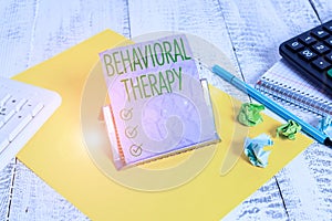 Handwriting text Behavioral Therapy. Concept meaning help change potentially selfdestructive behaviors Notepaper stand on buffer photo