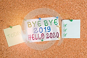 Handwriting text Bye Bye 2019 Hello 2020. Concept meaning Starting new year Motivational message 2019 is over Corkboard