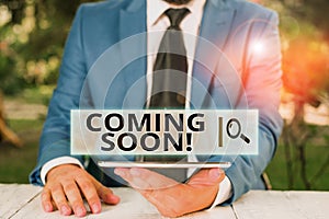 Handwriting text Coming Soon. Concept meaning event or action that will happen after really short time Businessman with mobile