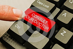 Hand writing sign Consult Your Doctor. Business approach ask information or advice from a medical professional Abstract