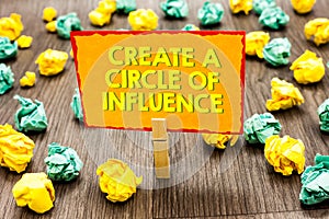 Handwriting text Create A Circle Of Influence. Concept meaning Be an influencer leader motivate other people Paperclip hold writte