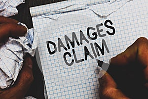 Handwriting text Damages Claim. Concept meaning Demand Compensation Litigate Insurance File Suit Man holding marker notebook crump photo