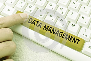 Handwriting text Data Management. Word Written on The practice of organizing and maintaining data processes Abstract