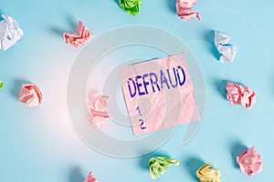 Handwriting text Defraud. Concept meaning to trick or cheat someone or something in order to get money Colored crumpled rectangle photo