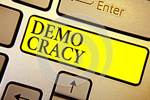 Handwriting text Demo Cracy. Concept meaning freedom of the people to express their feelings and beliefs Keyboard yellow key Inten