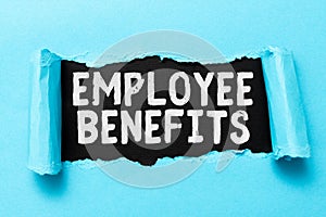 Handwriting text Employee Benefits. Internet Concept indirect and noncash compensation paid to an employee Tear on sheet photo