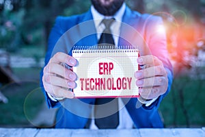 Handwriting text Erp Technology. Concept meaning the integrated management of main business processes Man holds empty paper with