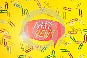 Handwriting text Fake News. Concept meaning Giving information to showing that is not true by the media Flat lay above photo
