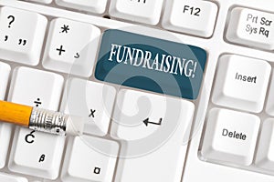 Handwriting text Fundraising. Concept meaning seeking to generate financial support for charity or cause White pc