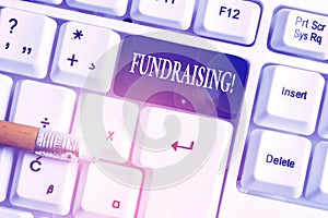 Handwriting text Fundraising. Concept meaning seeking to generate financial support for charity or cause White pc