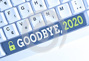 Handwriting text Goodbye 2020. Concept meaning New Year Eve Milestone Last Month Celebration Transition White pc photo