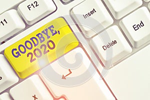 Handwriting text Goodbye 2020. Concept meaning New Year Eve Milestone Last Month Celebration Transition White pc keyboard with photo