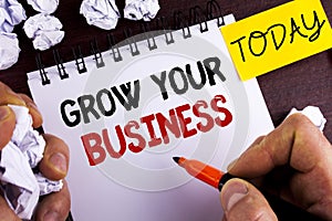 Handwriting text Grow Your Business. Concept meaning improve your work enlarge company overcome competitors written by Man on Note