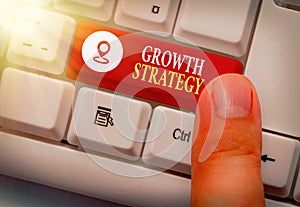 Handwriting text Growth Strategy. Concept meaning Strategy aimed at winning larger market share in shortterm photo