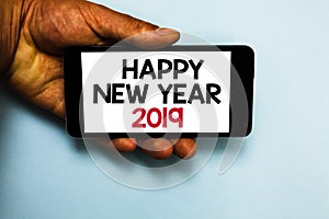 Handwriting text Happy New Year 2019. Concept meaning Greeting Celebrating Holiday Fresh Start Best wishes Human hand hold mobile