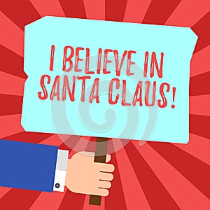 Handwriting text I Believe In Santa Claus. Concept meaning To have faith in Christmas Holiday childhood Hu analysis Hand Holding
