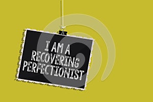 Handwriting text I Am A Recovering Perfectionist. Concept meaning Obsessive compulsive disorder recovery Hanging blackboard messag