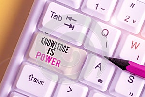 Handwriting text Knowledge Is Power. Concept meaning skills acquired through experience and education White pc keyboard