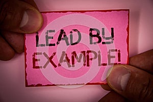 Handwriting text Lead By Example Motivational Call. Concept meaning Leadership Management Mentor Organization Words written pink p