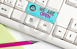 Handwriting text We Are Open. Concept meaning no enclosing or confining barrier, accessible on all sides Different photo