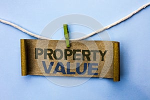 Handwriting text Property Value. Concept meaning Estimate of Worth Real Estate Residential Valuation written on Cardboard Paper ha